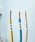 Heavy Duty 9MM Heat Shrink Tube Labels For Wire And Cable Marking compatible with Dymo Rhino on labeled wires in yellow, blue, and beige.