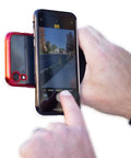 Universal Dual Phone Carrier With Strong Magnetic Mounts For Smart Device Storage. Dual holder securing two smartphones in use.