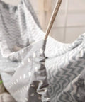 Close-up of grey Chill Nylon Baby Hammock Swing for indoor or outdoor use, showing fabric with zigzag and polka dots pattern.
