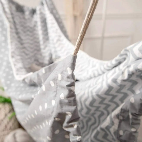 Close-up of grey Chill Nylon Baby Hammock Swing for indoor or outdoor use, showing fabric with zigzag and polka dots pattern.