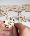 DIY Stress Relief 3D Puzzle Kit With Four Mini Models Self-Build Plywood Mechanics Featuring Tractor Cat Head And Heart For Adults And Kids Ages 5 To 80, hands assembling mini plywood head model