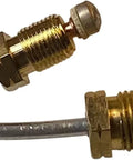 Close-up of brass water heater pilot assembly with thermocouple and copper tubing for natural gas