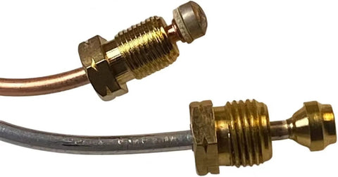 Close-up of brass water heater pilot assembly with thermocouple and copper tubing for natural gas