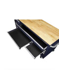 Badass 72 Inch Wide Mobile Workbench Tool Chest With Solid Wood Top Integrated Power Strip And 18 Hella Spacious Drawers For Rock Solid Gloss Blue Garage Storage showing oak surface and open drawers.