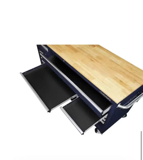 Badass 72 Inch Wide Mobile Workbench Tool Chest With Solid Wood Top Integrated Power Strip And 18 Hella Spacious Drawers For Rock Solid Gloss Blue Garage Storage showing oak surface and open drawers.