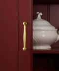 Brushed Gold Cabinet Pulls 5 Inch Hole Center 6 Pack Zinc Alloy Handles on red cabinet with white dish visible