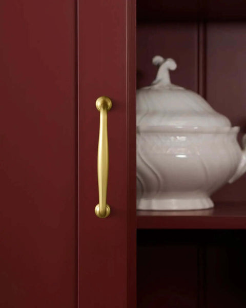 Brushed Gold Cabinet Pulls 5 Inch Hole Center 6 Pack Zinc Alloy Handles on red cabinet with white dish visible