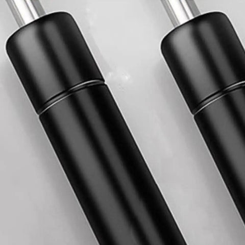 Close-up of Beefy 2 Pack 10 Inch Gas Prop Shocks 100N 22LB Black Gas Springs showing metal and black design.