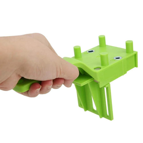 Hand holding a green Woodworking Doweling Jig Kit For Precise 6mm 8mm And 10mm Holes 8 Piece Drill Guide Set With Pro Grade Adjustable 0 To 50mm Border Drilling For Furniture Assembly And DIY Projects tool.