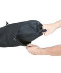 Hands holding BackLoader 15L Bikepacking Seat Bag With Water Repellent Durable Polyethylene And Nylon Construction For Stable Ride