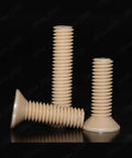 Top Shelf PEEK Plastic Phillips Countersunk Flat Head Screws M1.2 Through M8 Heavy Duty Polymer Fasteners on black backdrop.