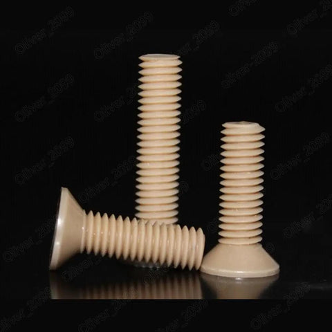 Top Shelf PEEK Plastic Phillips Countersunk Flat Head Screws M1.2 Through M8 Heavy Duty Polymer Fasteners on black backdrop.