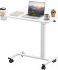 Smooth Operator Mobile Rolling Desk With Lockable Casters And Pneumatic Height Adjustment From Twenty Eight To Forty One Inches Perfect Overbed Bedside Table For Chill Laptop Setups In Bright White with coffee, laptop, and plant.