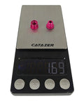 Pink 5 Pack 7075 Aluminum Chainring Bolts For Road And MTB Cranksets, 6.5mm Nuts on digital scale showing weight.