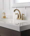 Modern bathroom with Arvo Centerset Bathroom Faucet Champagne Bronze 2 Handle 3 Hole Sink Faucet flowing water into white sink