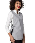 Heavy Duty Cobbler Apron Set Of Six With Deep Front Pockets And Adjustable Waist For Nurses Crafters And Mechanics Works Like A Champ Built Tough For The Daily Grind In Sharp Silver Gray worn by a smiling woman with curly hair.