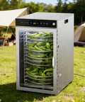 Straight Up Heavy Duty 16 Tray Commercial Stainless Steel Food Dehydrator With A Sleek Digital Interface And Adjustable Temps For Rapid Even Drying On Sweet Fruits Lean Meats And Herbs filled with green peppers outdoors.