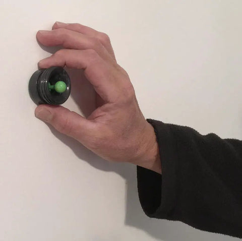 Hand using Magnetic Stud Finder No Batteries No Calibration 3X More Reliable For Lath And Plaster And Metal Studs With Visual And Audible Indicator Easy And Fun To Use 1 Inch Magnet on wall