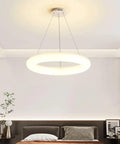 White Ring Acrylic LED Pendant Light for Bedroom, Modern Hanging Lamp, illuminating a contemporary bedroom ceiling.