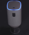 Front view of white cordless 5V electric air pump with blue LED ring and black power button.