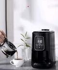 Compact Automatic Freshly Ground Coffee Brewer With Onboard Bean Grinder And Programmed Cup Settings pouring coffee into a white cup.