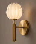 Modern Brushed Brass Wall Sconce Light - Fluted Alabaster Glass Shade Wall Mounted Lamp, side view on wall.