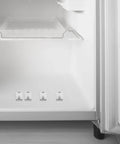 Interior of a fridge showing 4 Pack Stainless Steel Refrigerator Shelf Clips With Adjustable Support Hooks on lower shelf