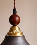 Top view of DWEIHDV Ceramic Wall Sconce Vintage Gold Wall Light Fixture showing brass and wooden details.