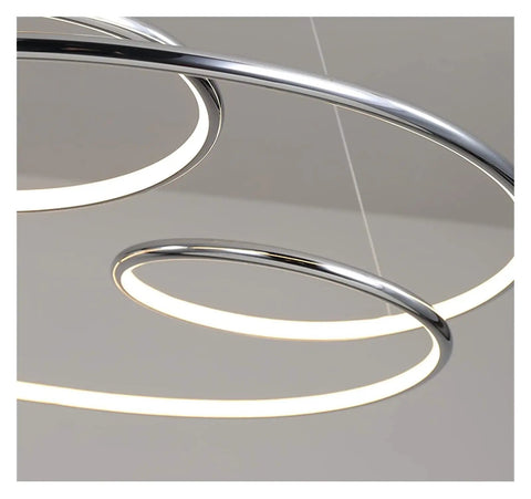 Sleek Modern Led Pendant Light For Kitchen And Office Featuring Minimalist Hanging Setup with circular chrome design and warm glow.