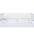 Front view of Full-Size Wood Daybed With Trundle And Fence Guardrails In White Finish showing sturdy pine frame and slatted base