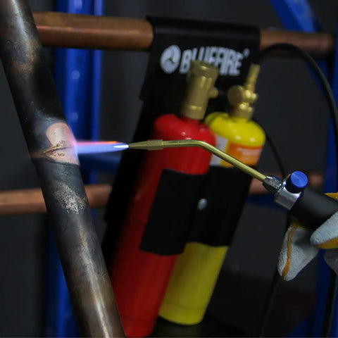 Oxypropane Welding Gas Cutting Torch Kit With Flint Lighter And Cylinder Holder Rack For Jewelers And HVAC Pros Pro Grade Brazing Soldering Map Gas Torch Set Heavy Duty Brass Fittings in use on a metal pipe.