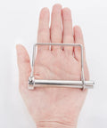 Front view: hand holding a 316 stainless steel square PTO shaft locking pin, 3/8 x 2-3/4 in