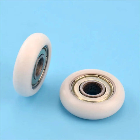 Two 5mm Pom Nylon Pulleys with circular arc design from 20pcs Circular Arc Plastic Coated 608ZZ Bearings on blue background.