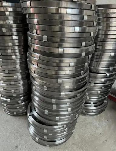 Heavy Duty Flat Steel Drain Cleaning Tape 2000 Cm Long stacked rolls of manganese steel for sewer clog removal.