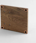 No Fuss 58mm Walnut Wood Espresso Tamper Station showing the sturdy base with rounded edges and mounting holes for secure countertop use.
