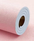 Stress Free Peel And Stick Wallpaper Roll, Removable Self Adhesive Vinyl With Thick Insulation Backing, DIY Accent Wall Glow Up For Laidback Home Vibes, Soft Pink Concrete Texture, Nine Millimeter, close-up of rolled wallpaper.