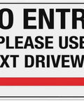 No entry sign with text "Please use next driveway" and a right-pointing red arrow.