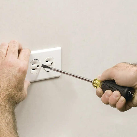 Person using USA Made Four Piece Slotted And Phillips Screwdriver Set With Cushion Grip Handles And Tip Ident on electrical outlet.