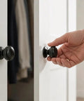 2 Pack Matte Black 1.6 Inch Large Bifold Closet Door Knobs With Wide 41mm Backplate For Full Coverage Renovation Ready Covers Old Marks And Exposed Screw Holes Easy Upgrade For Modern Closets on white closet doors
