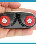 Hand holding 2 Pack Aluminum Kayak Cam Cleats For Kayak Boat Canoe And Dinghy Fast Entry Rope Cleats 15mm Capacity