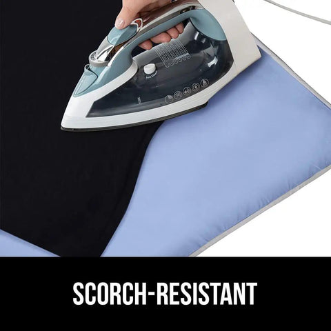 Ironing on a Magnetic Ironing Blanket Travel Size 28x24 with Silicone Coating Scorch Resistant Up To 400 Degrees.