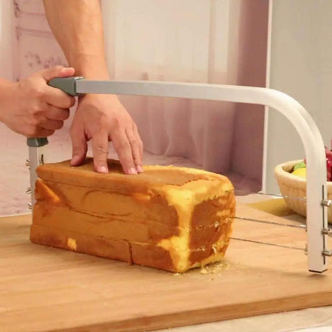 Adjustable Cake Leveler And Wire Slicer For Even Layer Cakes Pro Grade Stainless Steel Cutter in use on a sponge cake