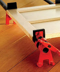 Two red Bessey BPC-H34 3/4-in H-style pipe clamps securing a wooden frame.