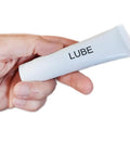 Hand holding tube of Silicone Treadmill Belt Lubricant For Smooth Quiet Runs And Easy Maintenance Walking Pad Lube With Easy Apply Solution To Cut Friction And Extend Belt Life Hundred Percent Silicone Oil