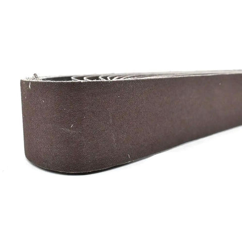 Close-up of HPG120-10 One And One Half Inch By Thirty Inch Aluminum Oxide Sanding Belt, 120 Grit showing edge and texture, ten pack.