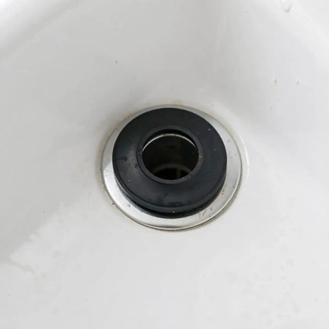 Close-up of a black rubber gasket in a bathtub drain, part of 10pcs Black Rubber Bathtub Drain Gasket, Leak Proof Seal Washer.