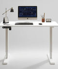 55 Inch Electric Height Adjustable Standing Desk Ultra Quiet Sit To Stand Work Table in white with monitor and accessories on top.
