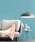 Modern Nordic Style Hanging Lamp Fixture Featuring Solid Wood Accents And Durable Iron Base Super Sleek Green Metal Shade For Kitchen Island Dining Table Bedroom Cozy Hangout Vibe above light gray sofa with pink throw.