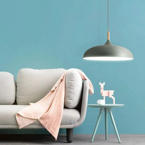 Modern Nordic Style Hanging Lamp Fixture Featuring Solid Wood Accents And Durable Iron Base Super Sleek Green Metal Shade For Kitchen Island Dining Table Bedroom Cozy Hangout Vibe above light gray sofa with pink throw.