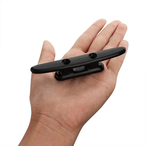 Heavy Duty 4 Inch Black Nylon Marine Dock Cleats 4 Pack With Premium Stainless Steel Screws held in hand for secure boat mooring.